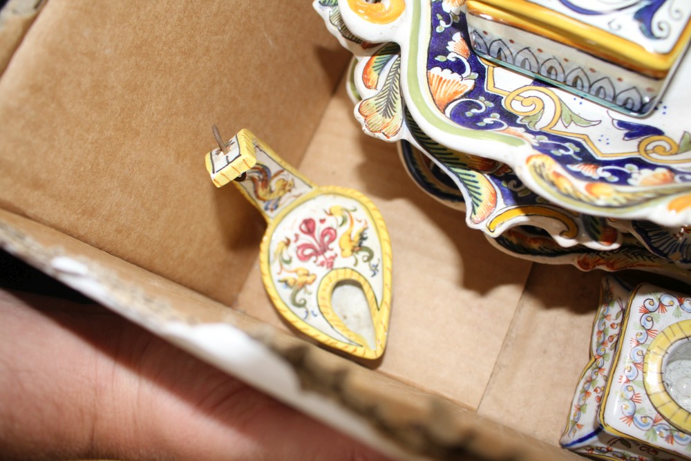 A collection of five St Malo faience dishes, a similar chamberstick, two inkwells, an unsigned oil lamp and a Deruta casket